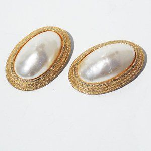 Large faux pearl clip-on statement earrings mounted in a gold-tone metal